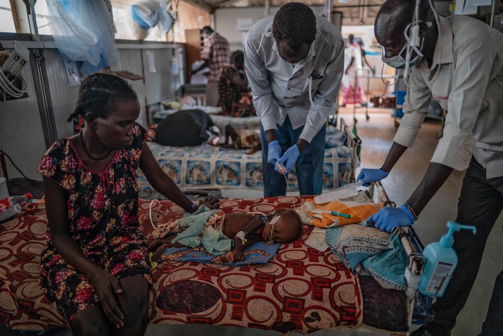 Nyanhial and baby Chuong. Almost all the children in the camp are malnourished.