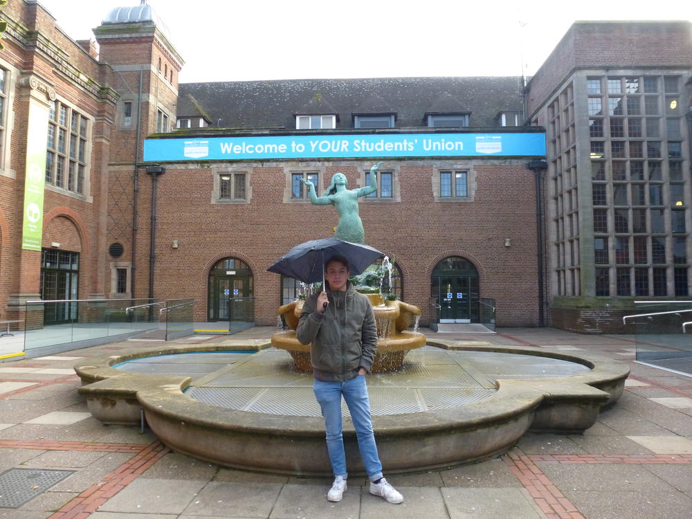 Ben Heiden with the requisite umbrella in front of the Guild of Students, where the weekly student union party is held.