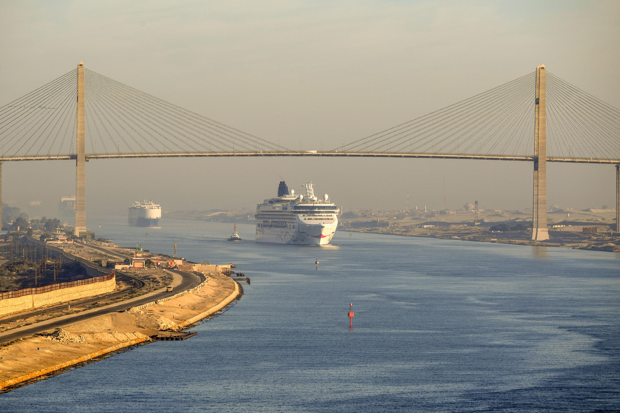Passage mit Gegenverkehr. Ein Kreuzfahrtschiff fährt nahe al-Quantara, Ägypten, unter der Suezkanalbrücke hindurch. Die Wasserstraße kann seit wenigen Jahren in beiden Richtungen passiert werden.